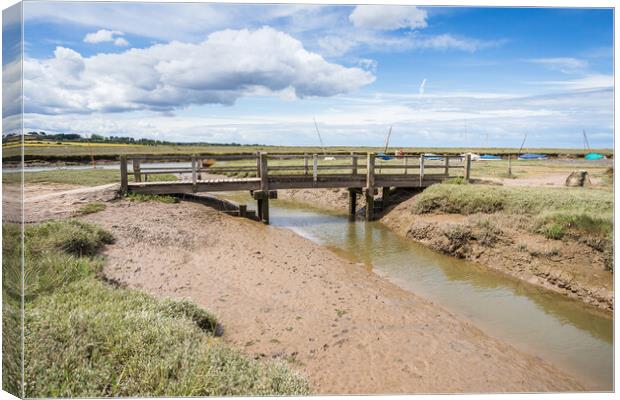 Bridge over a channel at Blakeney Canvas Print by Jason Wells