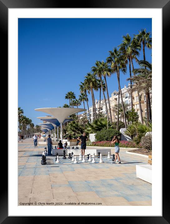 Estepona promenade chess game Framed Mounted Print by Chris North