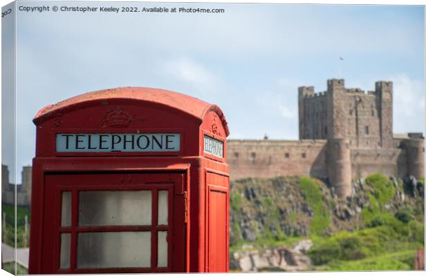 Bamburgh Castle red telephone box Canvas Print by Christopher Keeley