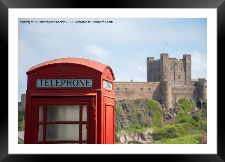 Bamburgh Castle red telephone box Framed Mounted Print by Christopher Keeley
