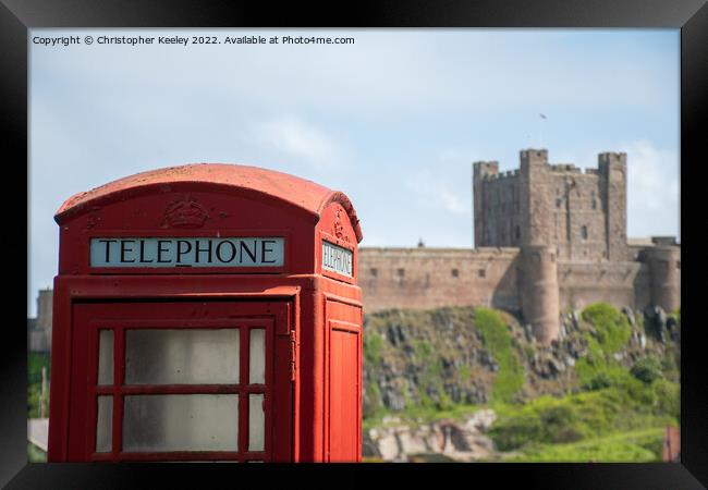 Bamburgh Castle red telephone box Framed Print by Christopher Keeley
