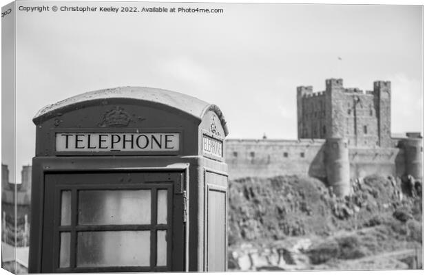 Black and white Bamburgh Castle telephone box Canvas Print by Christopher Keeley