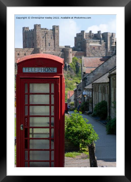 Red telephone box and Bamburgh Castle Framed Mounted Print by Christopher Keeley