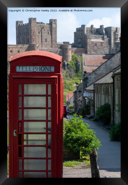 Red telephone box and Bamburgh Castle Framed Print by Christopher Keeley