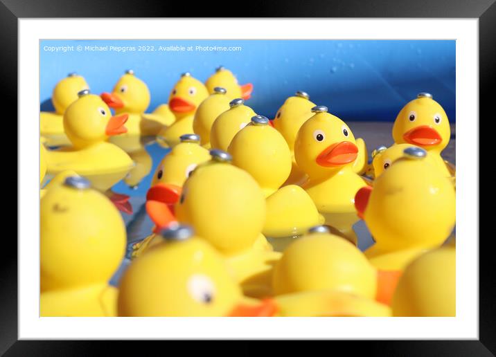 Selective focus. Many yellow rubber ducks swimming in circles in Framed Mounted Print by Michael Piepgras