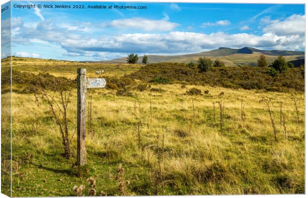 Wooden Post Aiming at Pen y Fan and Corn Du  Canvas Print by Nick Jenkins