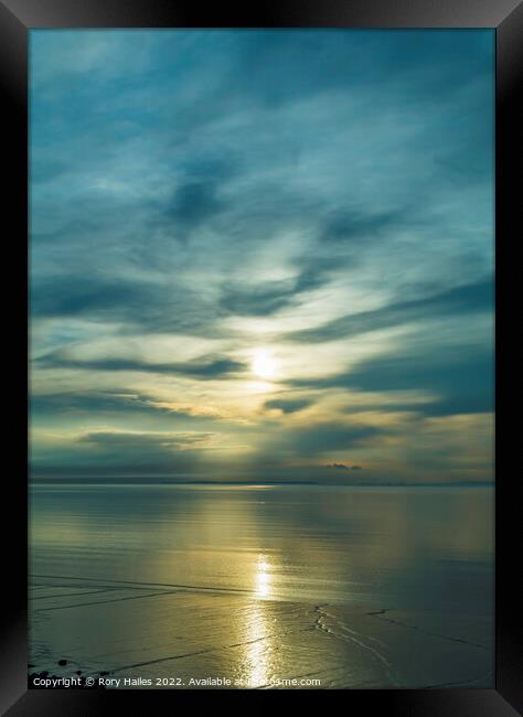 Sunlight reflecting onto sea Framed Print by Rory Hailes