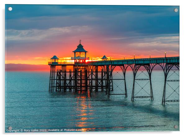 Clevedon Pier at sunset with a reddish orangey glow in the background Acrylic by Rory Hailes