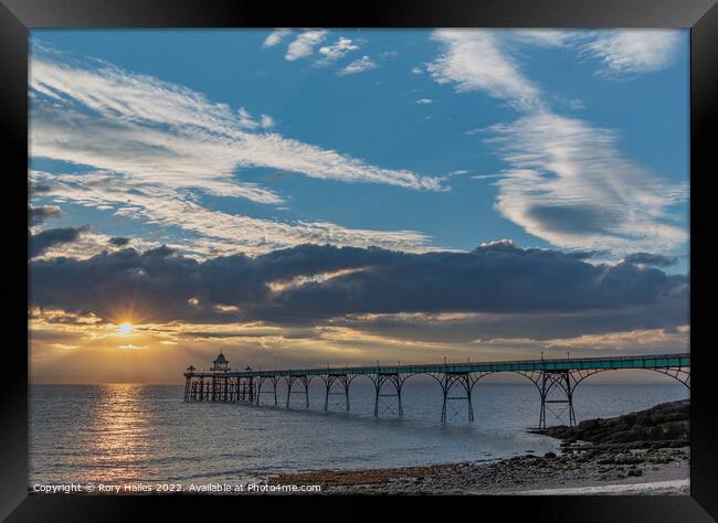 Clevedon Pier with a streak of sunlight going across the channel Framed Print by Rory Hailes