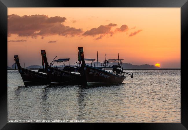 Long tail boats at sunrise. Framed Print by Kevin Hellon
