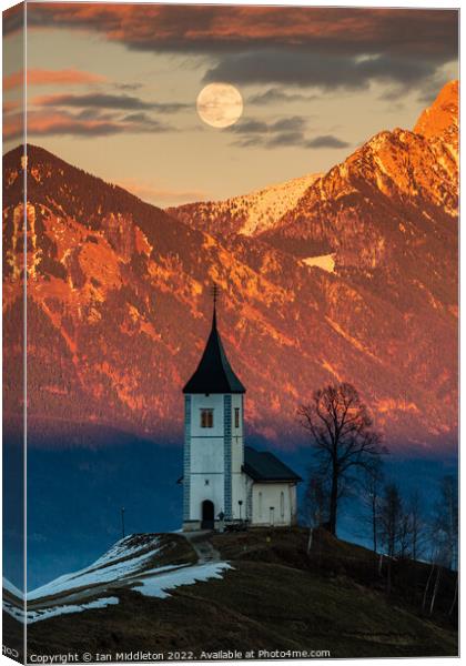Full moon rising over Jamnik church and Storzic at sunset Canvas Print by Ian Middleton