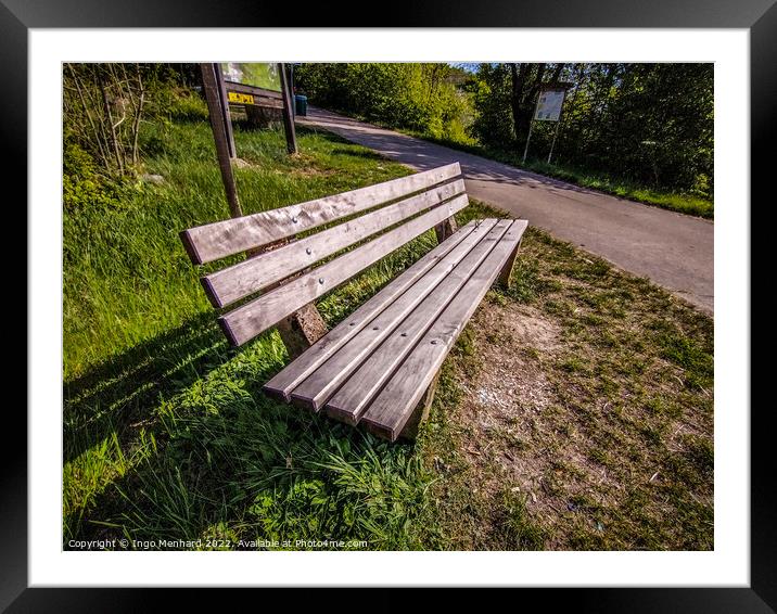 High angle shot of a bench near a street Framed Mounted Print by Ingo Menhard