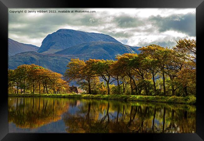 Caledonian Canal with a line of autumnal trees reflecting in the canal Framed Print by Jenny Hibbert