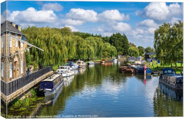Boats moored on the River Great Ouse at Ely Canvas Print by Angus McComiskey