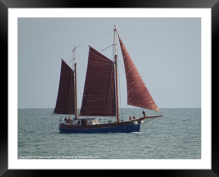 Sailboat passing Hastings. Framed Mounted Print by Mark Ward