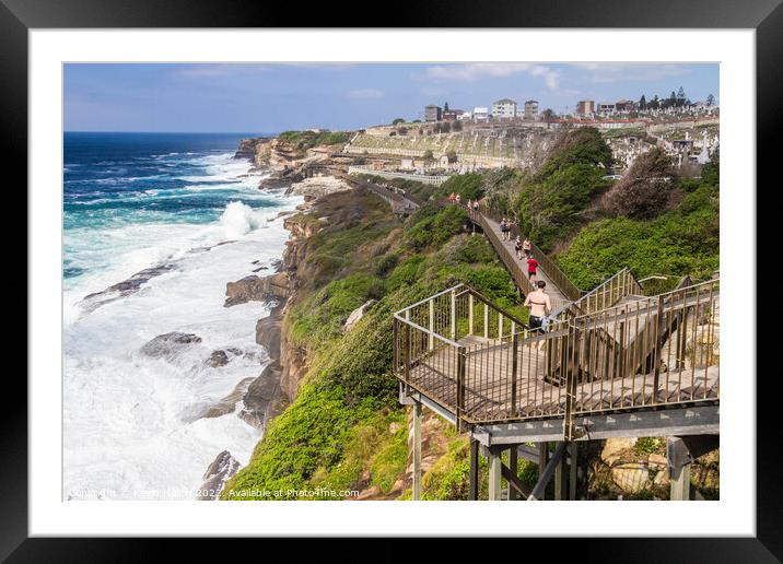 The Bondi to Coogee coastal walk with rough seas and Waverley ce Framed Mounted Print by Kevin Hellon