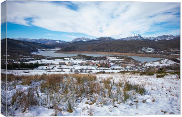 lakeside village in the snow capped mountains Canvas Print by David Galindo