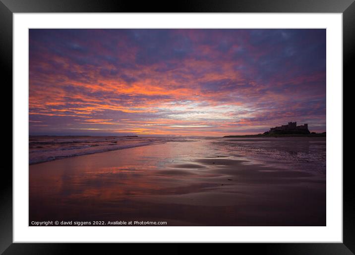 Bamburgh castle and beach sunrise Framed Mounted Print by david siggens