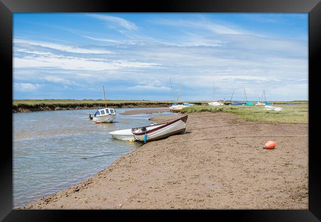 Boats along a channel at Blakeney Framed Print by Jason Wells