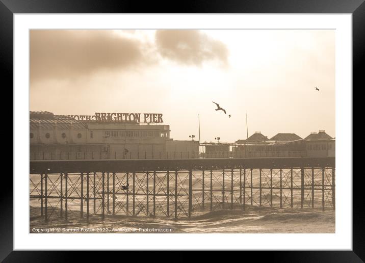 Brighton Pier on a stormy windy day with sun coming through clouds Framed Mounted Print by Samuel Foster