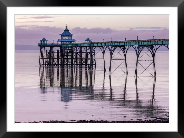 Clevedon Pier with its leg reflecting onto a calm sea Framed Mounted Print by Rory Hailes
