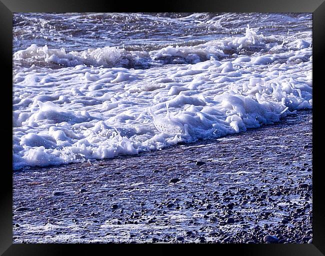 Silky Ripples on Pebble Beach Framed Print by Roger Mechan