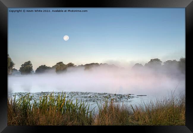 Misty pond with moon in the sky Framed Print by Kevin White