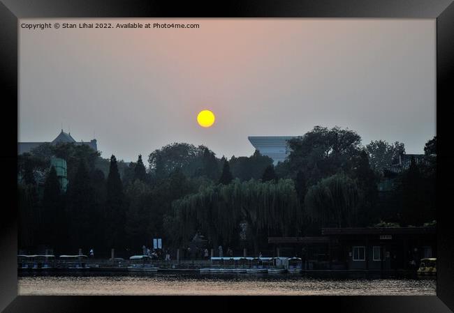 Sun disc over the park in Beijing Framed Print by Stan Lihai