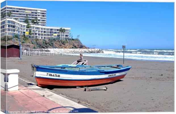 Beached rowboat, Torremolinos, Spain. Canvas Print by john hill