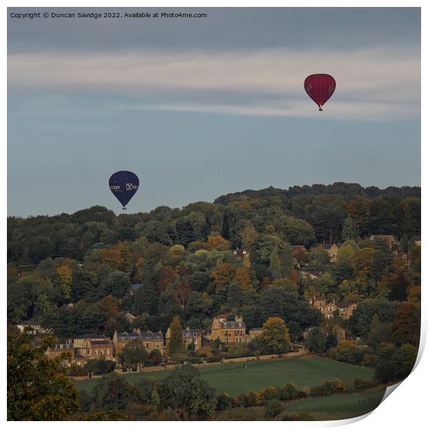 Two hot air balloons coming into land at Sham Castle in Bath Print by Duncan Savidge