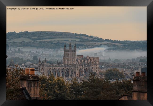 Moody early morning mist rising behind Bath Abbey Framed Print by Duncan Savidge