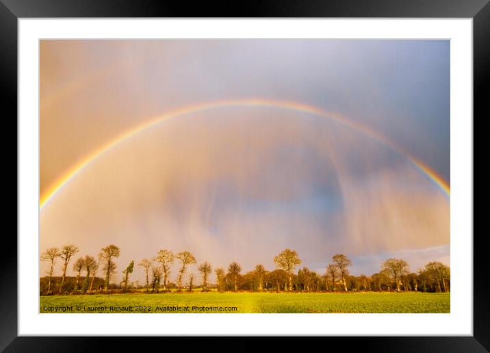 Rainbow over stormy sky in rural Brittany Framed Mounted Print by Laurent Renault