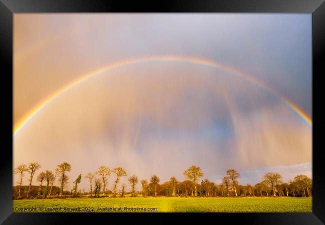 Rainbow over stormy sky in rural Brittany Framed Print by Laurent Renault