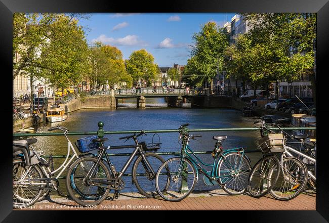 Bridge, canal view and bikes - Amsterdam Framed Print by Michael Shannon