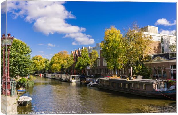 Canal and house boats - Amsterdam Canvas Print by Michael Shannon