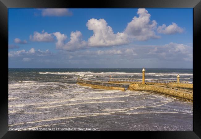 Clifftop view of the piers in Whitby, North Yorksh Framed Print by Michael Shannon