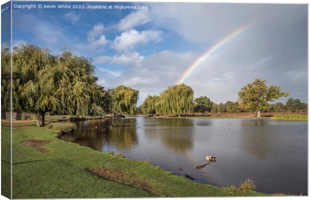 Rainbow over ponds Canvas Print by Kevin White