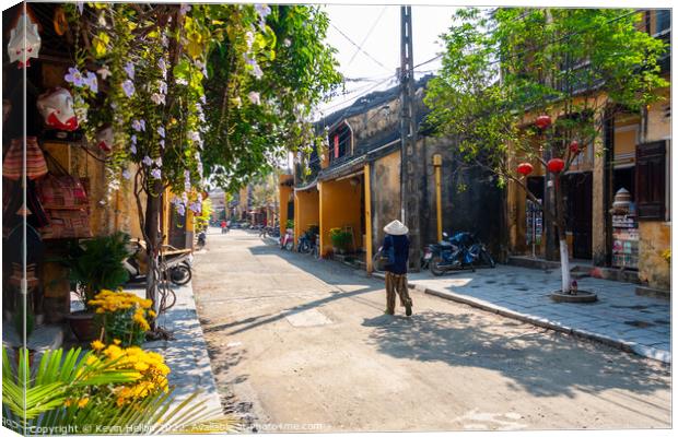 Typical street, Hoi An, Vietnam Canvas Print by Kevin Hellon