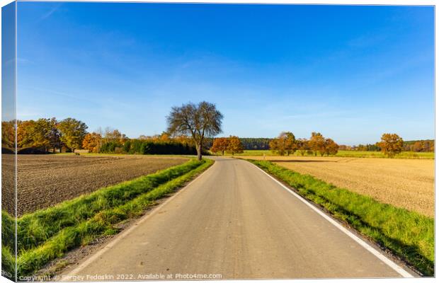 Sunny autumn day in european countryside. Rural road. Czech Republic. Canvas Print by Sergey Fedoskin