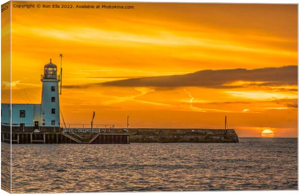 Scarborough Lighthouse at Sunrise Canvas Print by Ron Ella