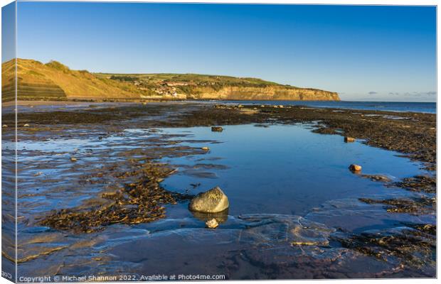 Beach at Boggle Hole and view towards Robin Hood's Canvas Print by Michael Shannon