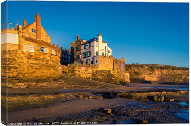 Robin Hoods Bay shot from the beach at low tide. Canvas Print by Michael Shannon