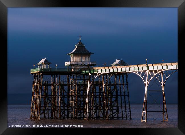 Clevedon Pier. at low tide with moody sky Framed Print by Rory Hailes