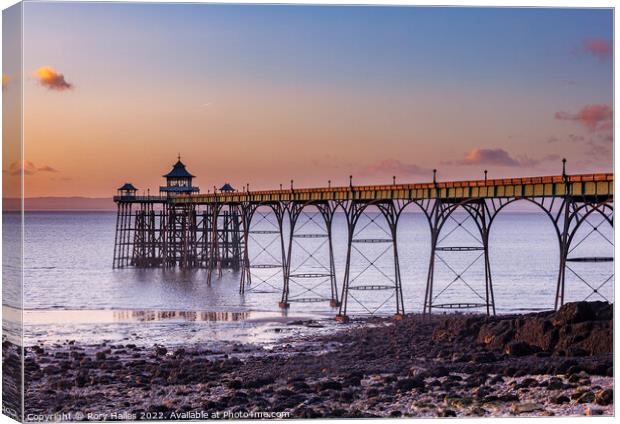 Clevedon Pier at sunset and low tide Canvas Print by Rory Hailes
