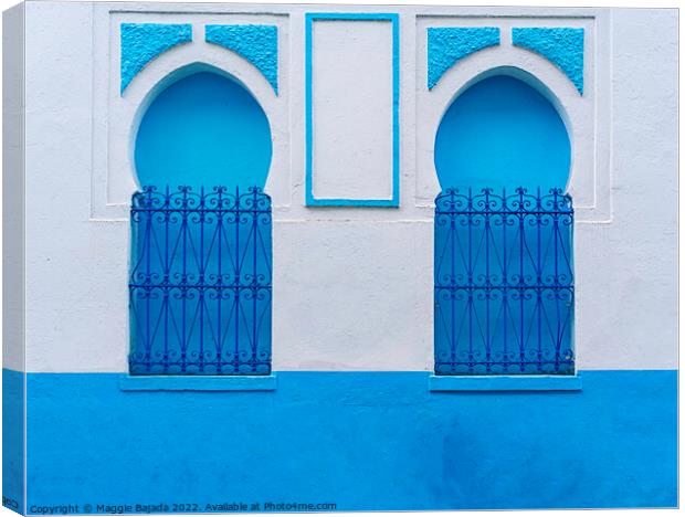 Decorative Blue and White Arch Wall with Iron fence, Morocco Canvas Print by Maggie Bajada