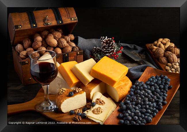 Variety of cheese on a wooden board Framed Print by Ragnar Lothbrok