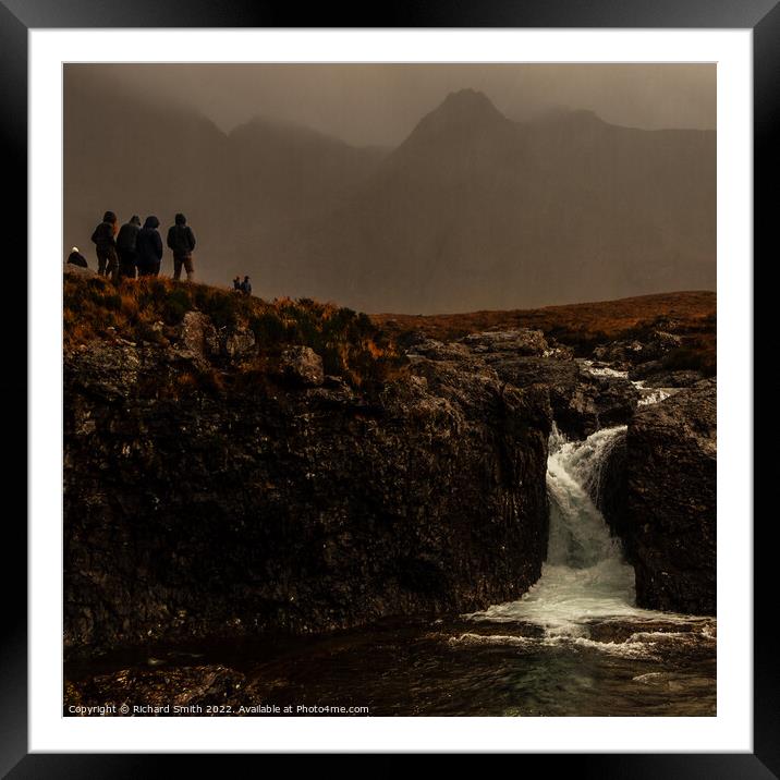 A group of people with their backs to the rain. Framed Mounted Print by Richard Smith