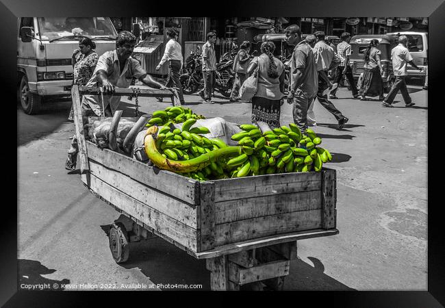 Man pushing crt of bananas in Colombo, Sri Lanka Framed Print by Kevin Hellon