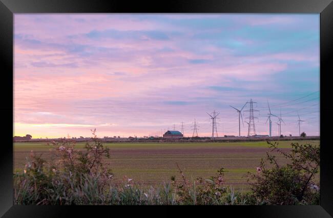 Pylons and wind turbines at daybreak Framed Print by Sally Wallis
