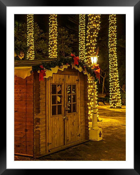 Christmas Hut with Night lights Decorations. Framed Mounted Print by Maggie Bajada